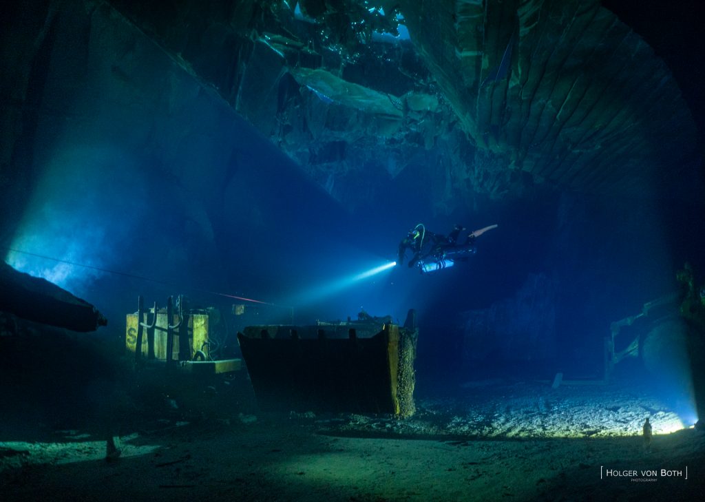 Technical diver exploring historic chambers inside Felicitas slate mine in Germany.