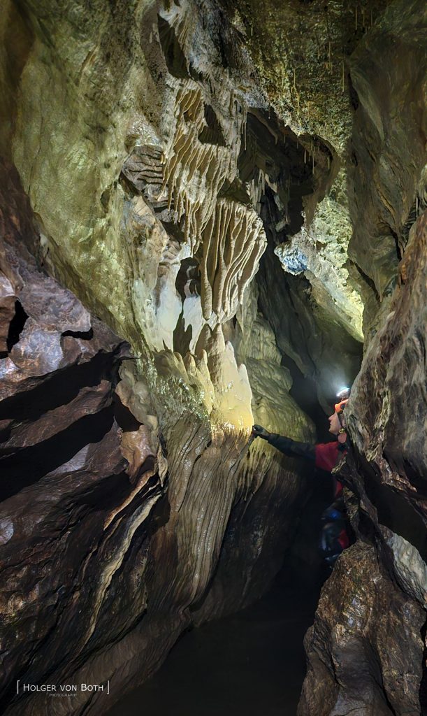 Cave diver exploring dry cave in Switzerland