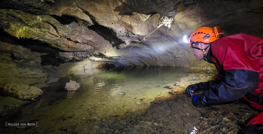 Cave diver exploring cave in Switzerland