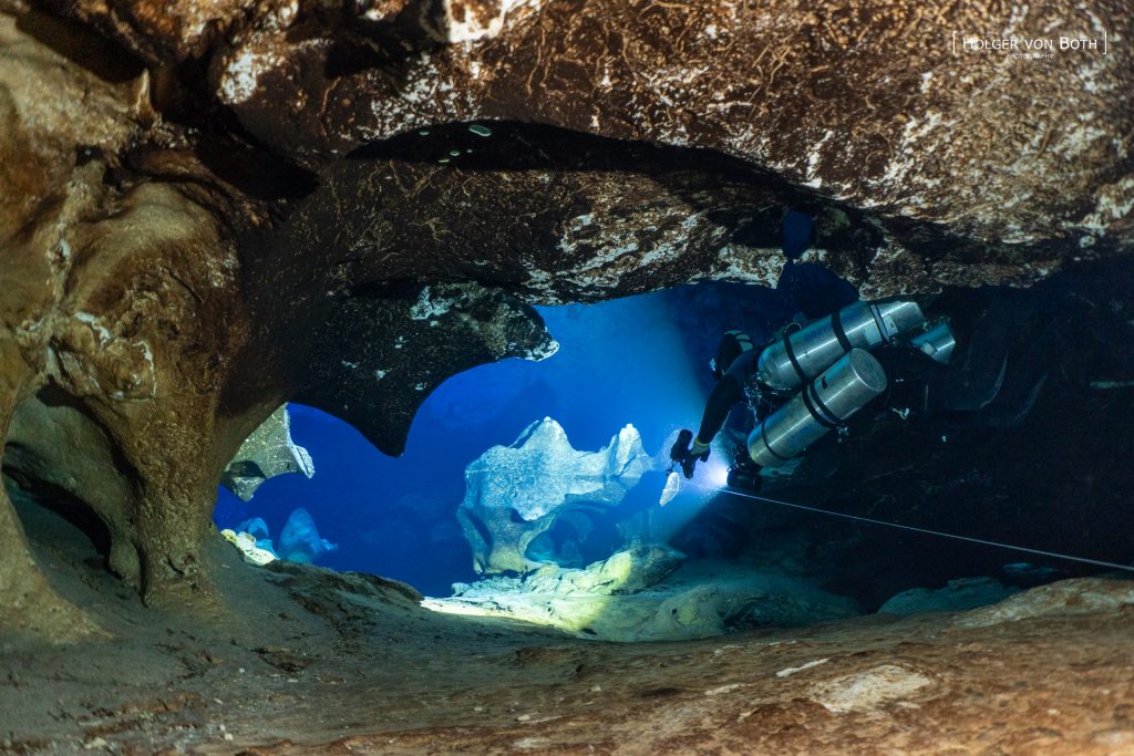 Technical cave diver exploring submerged passages inside Anjanamba Cave in the remote Mikea Forest region of Madagascar